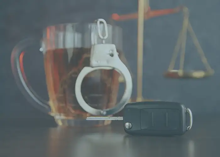 car keys, hand cuffs, and a glass of beer