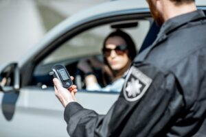 Police officer administering a breathalyzer test during a DUI stop in South Carolina