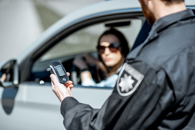 Police officer administering a breathalyzer test during a DUI stop in South Carolina